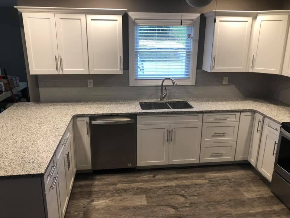Speckled granite countertop in white shaker kitchen